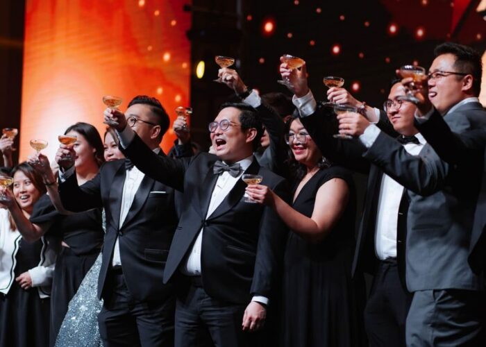 Guests raising glasses during a formal corporate event celebration